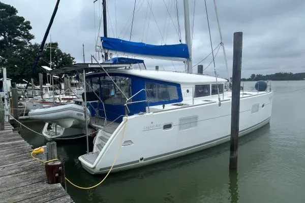 Halldis Yacht Photos Pics 2011 Lagoon 400 catamaran docked at a marina on a cloudy day.