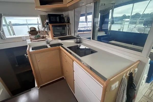 Halldis Yacht Photos Pics Modern kitchen interior of 2011 Lagoon 400 catamaran with sleek countertops and appliances.