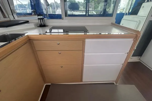 Halldis Yacht Photos Pics Modern kitchen area in a 2011 Lagoon 400 catamaran with sleek cabinetry and countertop.