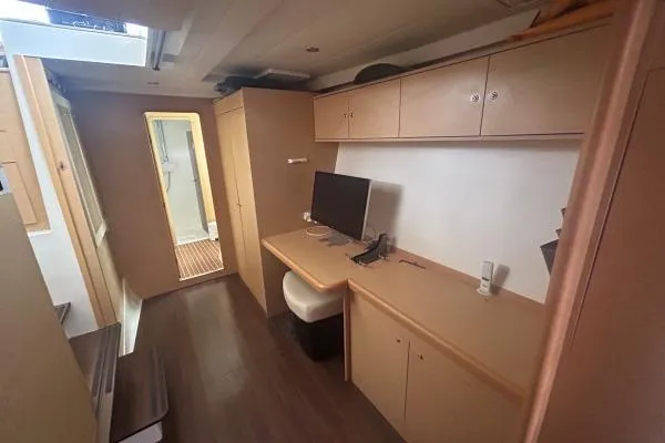 Halldis Yacht Photos Pics Interior of 2011 Lagoon 400 yacht with desk, chair, and storage cabinets.