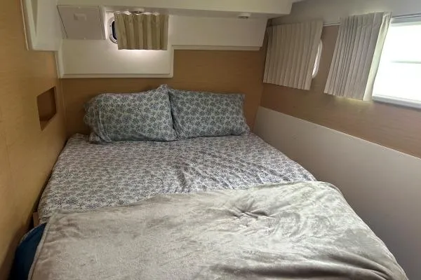 Halldis Yacht Photos Pics Cozy bedroom interior of 2011 Lagoon 400 catamaran with patterned bedding and soft lighting.