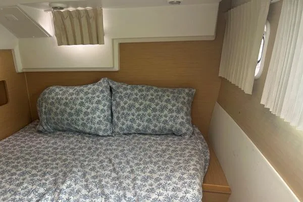 Halldis Yacht Photos Pics Cozy cabin bedroom in 2011 Lagoon 400 catamaran with patterned bedding and natural light.