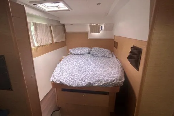 Halldis Yacht Photos Pics Cozy bedroom interior of 2011 Lagoon 400 catamaran with double bed and natural light.