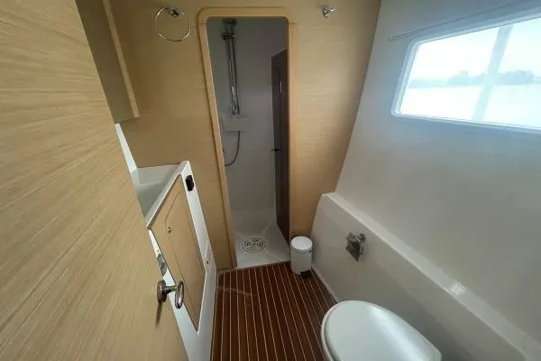 Halldis Yacht Photos Pics Bathroom interior of 2011 Lagoon 400 yacht with shower and wooden flooring.