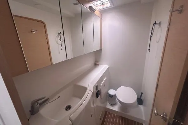 Halldis Yacht Photos Pics Bathroom interior of 2011 Lagoon 400 catamaran with modern fixtures and wooden accents.