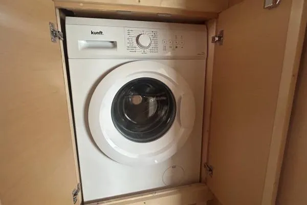 Halldis Yacht Photos Pics Front-loading washing machine in wooden cabinet on Lagoon 400, 2011 model.