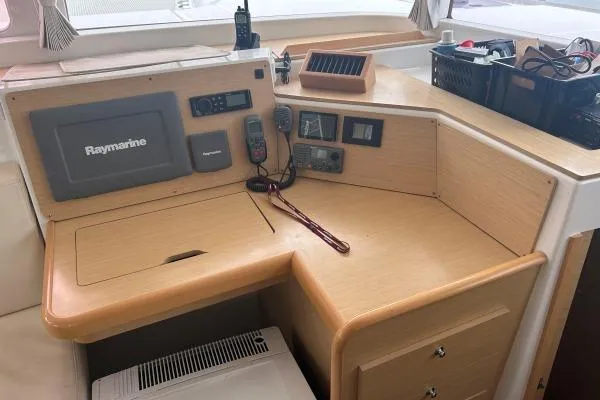 Halldis Yacht Photos Pics Navigation station of 2011 Lagoon 400 catamaran with Raymarine equipment and wooden finish.
