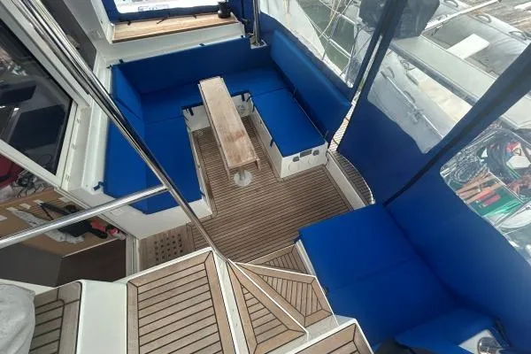 Halldis Yacht Photos Pics Interior view of 2011 Lagoon 400 catamaran with blue seating and wooden flooring.