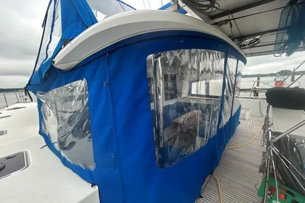 Halldis Yacht Photos Pics 2011 Lagoon 400 sailboat with blue canopy and clear windows on deck.