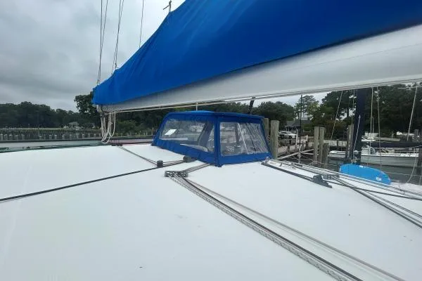 Halldis Yacht Photos Pics Sailboat deck of 2011 Lagoon 400 with blue canopy in marina setting.