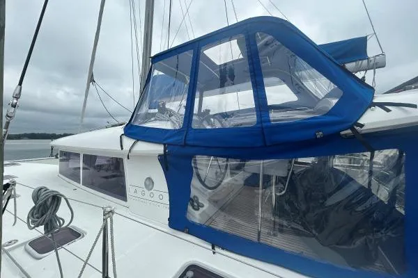 Halldis Yacht Photos Pics 2011 Lagoon 400 catamaran with blue canopy, docked on a cloudy day.