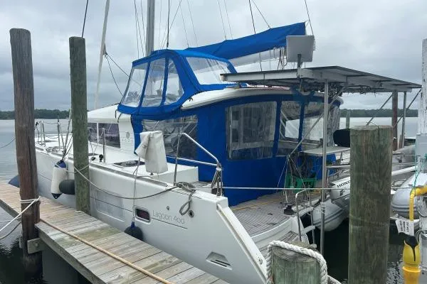 Halldis Yacht Photos Pics 2011 Lagoon 400 catamaran docked, featuring blue canopy and white hull.