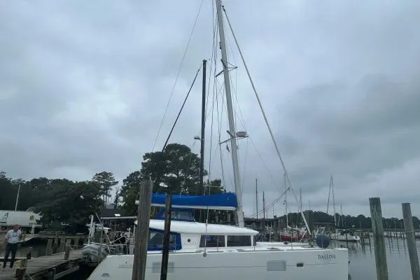 Halldis Yacht Photos Pics 2011 Lagoon 400 catamaran docked at a marina under cloudy skies.