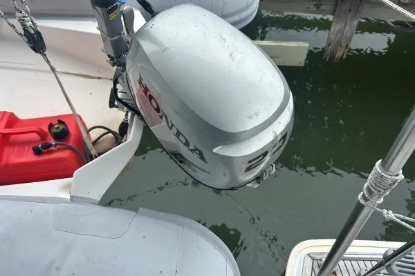 Halldis Yacht Photos Pics Outboard motor on a 2011 Lagoon 400 catamaran, docked by the water.