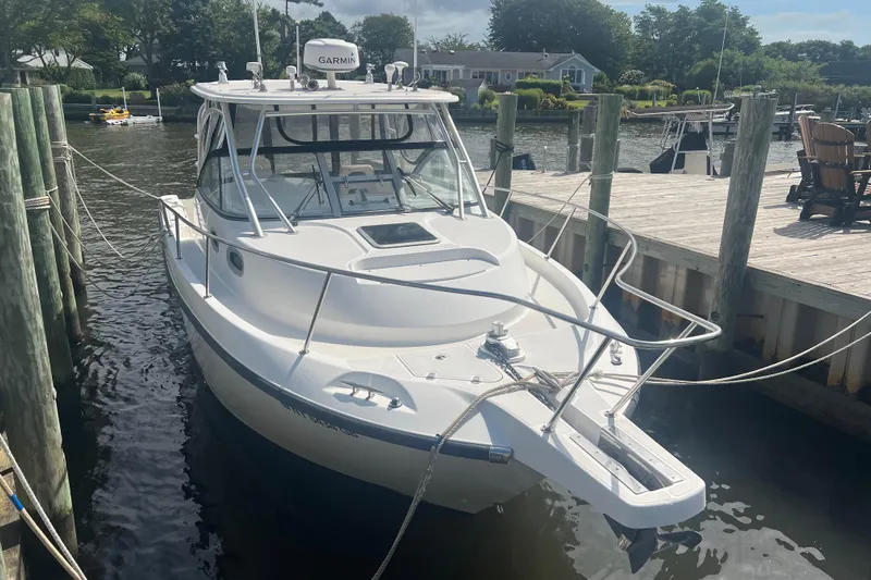  Yacht Photos Pics 2004 Boston Whaler 305 Conquest docked at a marina, featuring a Garmin system.