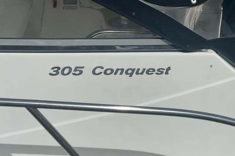  Yacht Photos Pics 2004 Boston Whaler 305 Conquest boat nameplate detail.
