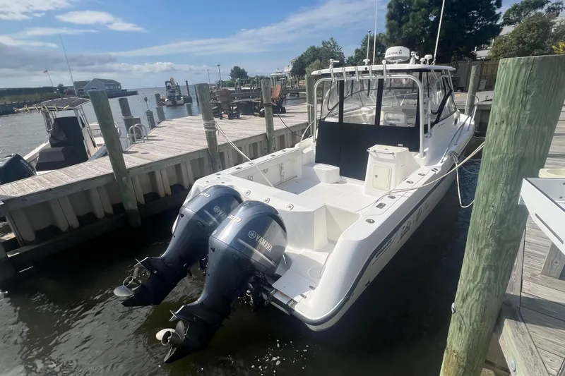  Yacht Photos Pics 2004 Boston Whaler 305 Conquest docked with twin Yamaha outboard engines.