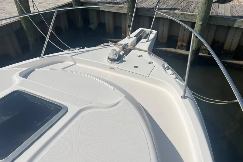  Yacht Photos Pics Bow of 2004 Boston Whaler 305 Conquest docked, featuring sleek design and sturdy railings.
