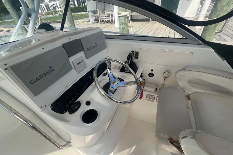  Yacht Photos Pics 2004 Boston Whaler 305 Conquest helm with Garmin navigation and steering wheel.