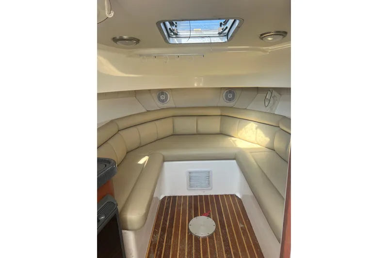  Yacht Photos Pics Interior cabin of 2004 Boston Whaler 305 Conquest with beige seating and wood flooring.