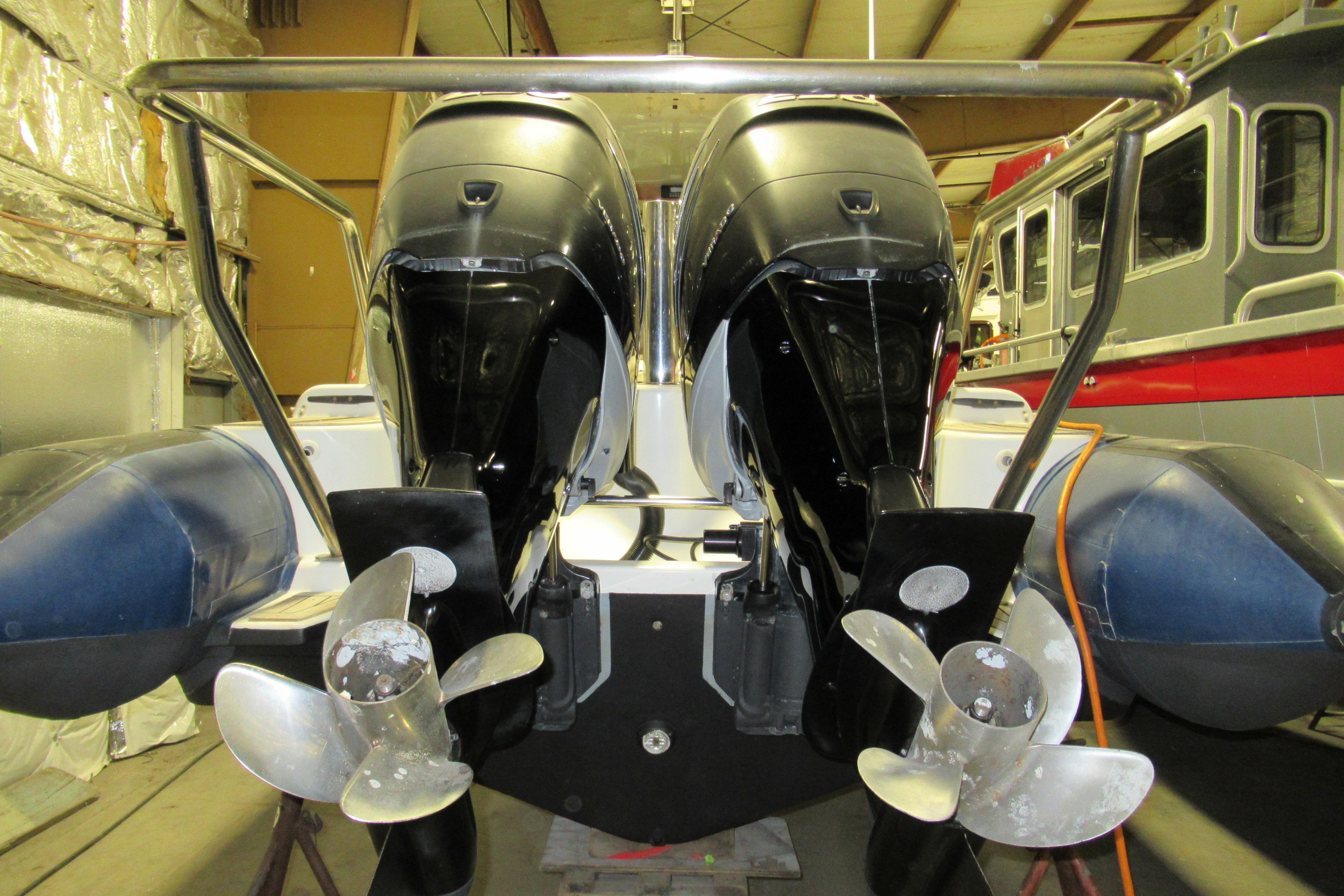 2007 Protector Targa 28 boat with dual outboard motors in a storage facility.