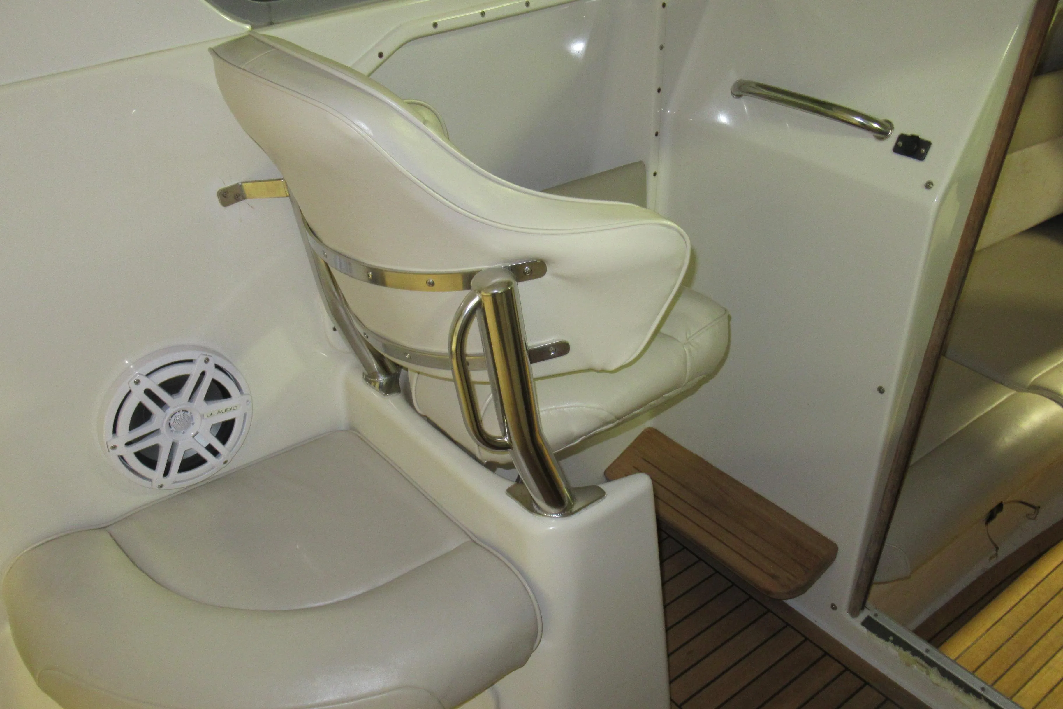 2007 Protector Targa 28 interior with white seating and speaker detail.