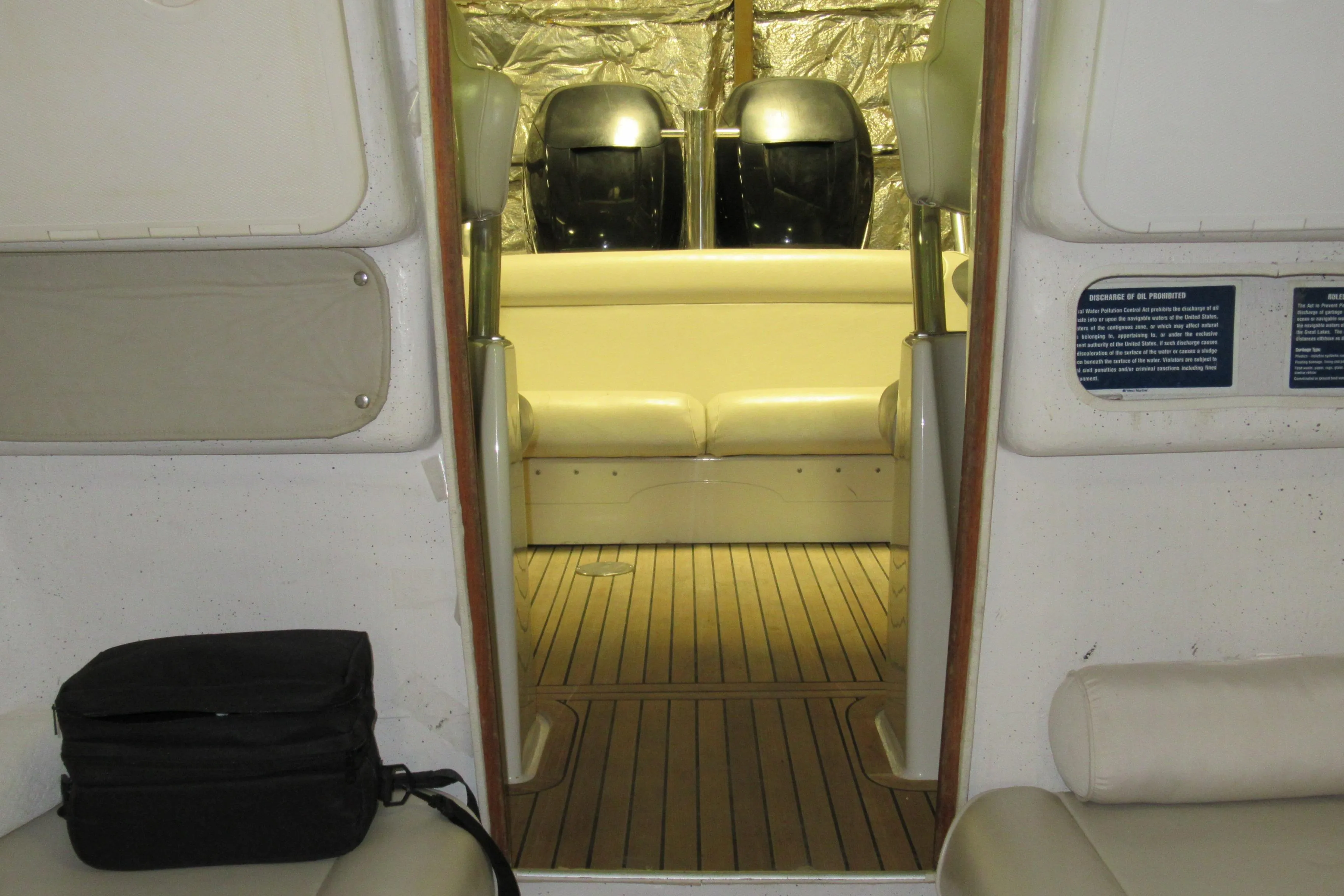 Interior view of 2007 Protector Targa 28 boat with seating and wooden flooring.