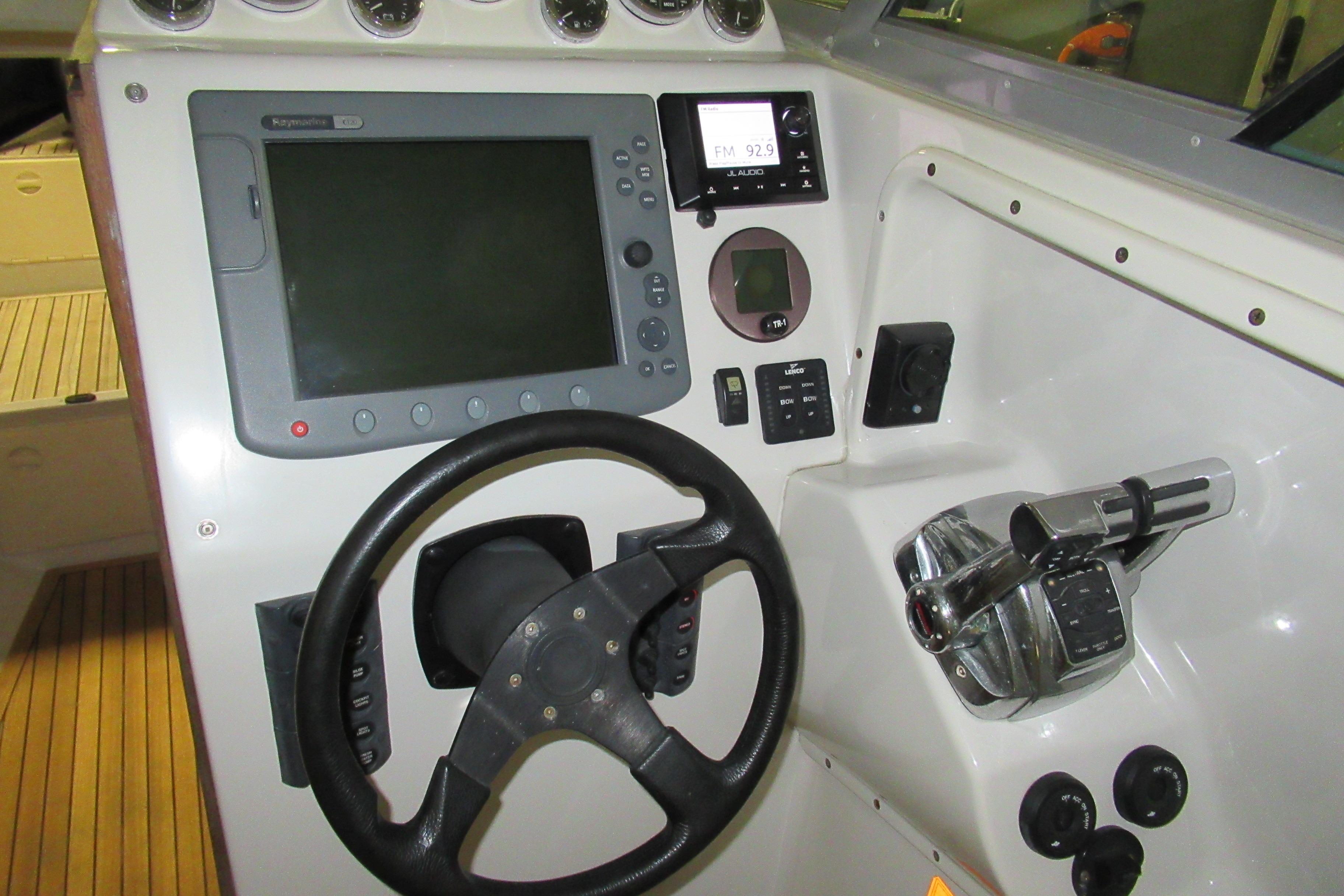 2007 Protector Targa 28 boat dashboard with steering wheel and navigation controls.