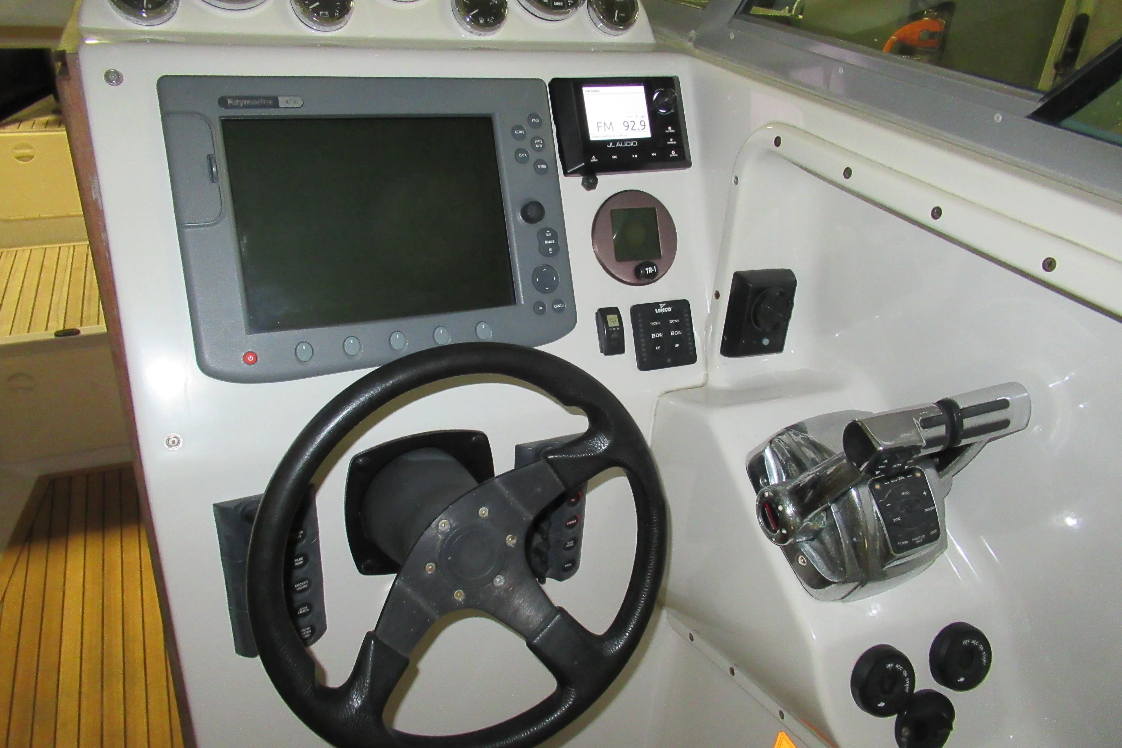 2007 Protector Targa 28 boat dashboard with steering wheel and navigation controls.