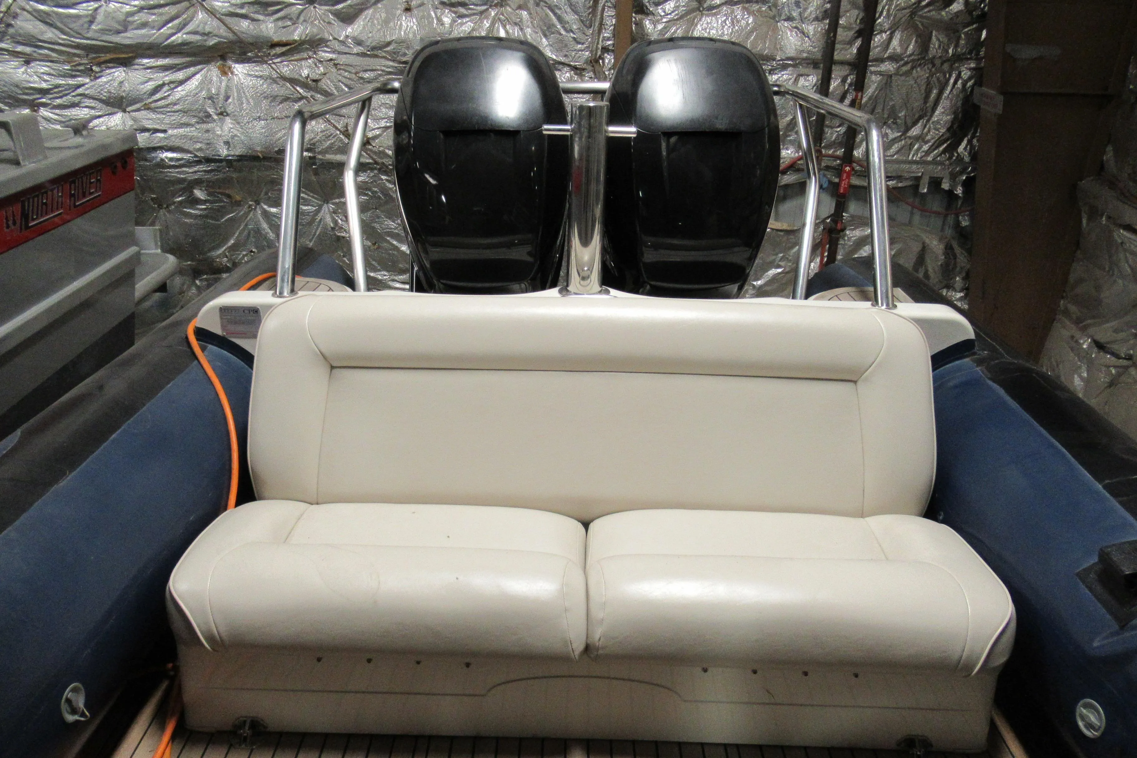 2007 Protector Targa 28 boat interior with white seating and dual engines.