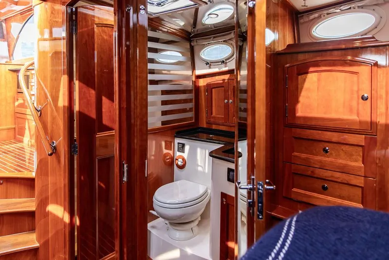 Kite Yacht Photos Pics Luxurious 2014 Hinckley Talaria 43 yacht bathroom with wooden cabinetry and modern fixtures.