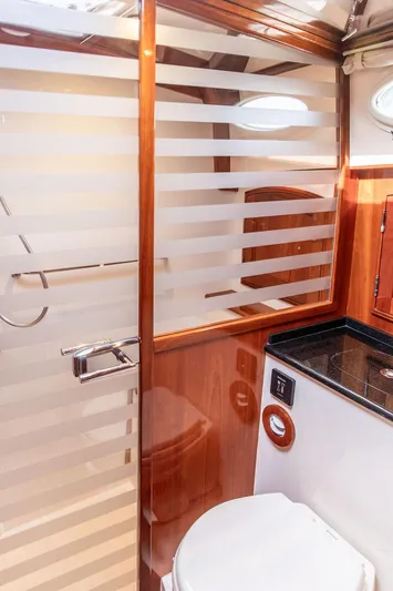 Kite Yacht Photos Pics Luxury bathroom in 2014 Hinckley Talaria 43 yacht with modern fixtures and wood accents.