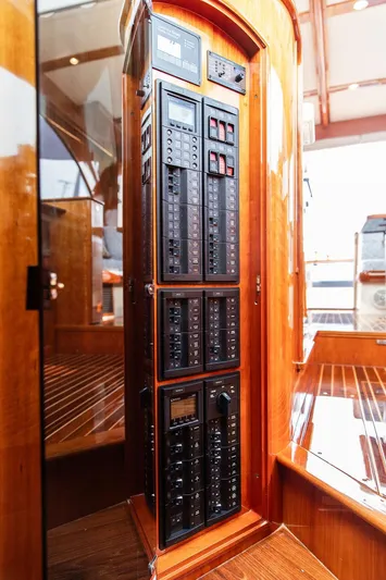 Kite Yacht Photos Pics Electrical panel inside 2014 Hinckley Talaria 43 yacht, featuring polished wood finish.