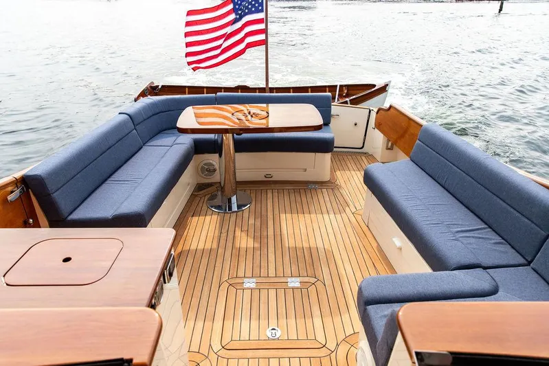 Kite Yacht Photos Pics 2014 Hinckley Talaria 43 yacht with teak deck and blue seating, American flag waving.