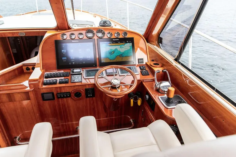 Kite Yacht Photos Pics Helm of 2014 Hinckley Talaria 43 yacht with wooden dashboard and modern navigation screens.