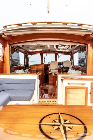 Kite Yacht Photos Pics Interior of 2014 Hinckley Talaria 43 yacht with wooden finishes and seating.