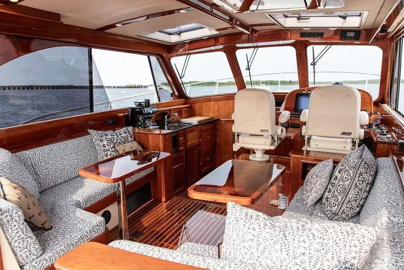 Kite Yacht Photos Pics Luxurious interior of 2014 Hinckley Talaria 43 yacht with elegant wood finish and plush seating.