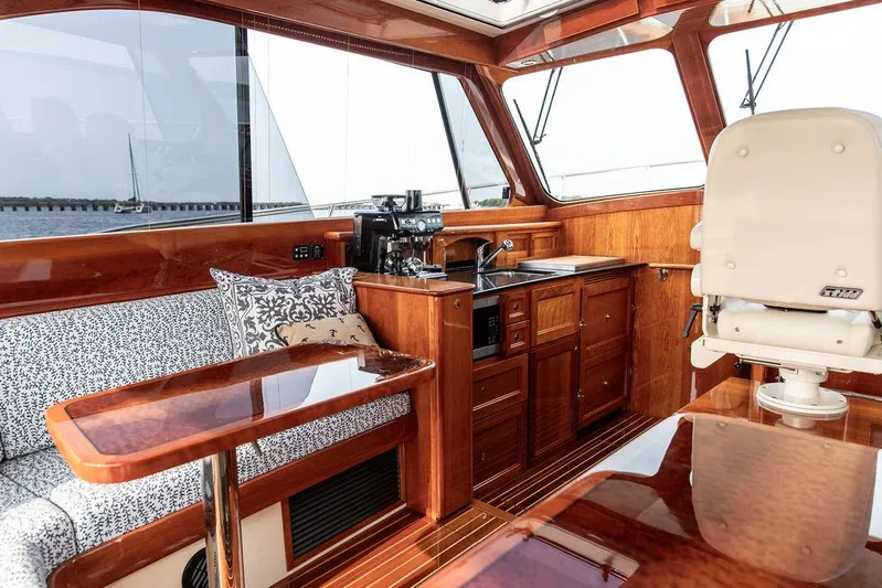 Kite Yacht Photos Pics Luxurious interior of 2014 Hinckley Talaria 43 yacht with wood finish and seating area.