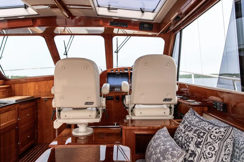 Kite Yacht Photos Pics Interior of 2014 Hinckley Talaria 43 yacht with elegant wood finish and helm seats.