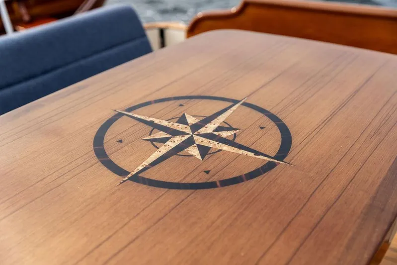 Kite Yacht Photos Pics Wooden table with compass rose design on 2014 Hinckley Talaria 43 yacht.