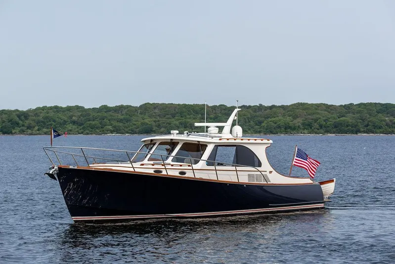 Kite Yacht Photos Pics 2014 Hinckley Talaria 43 yacht on calm water with American flag.
