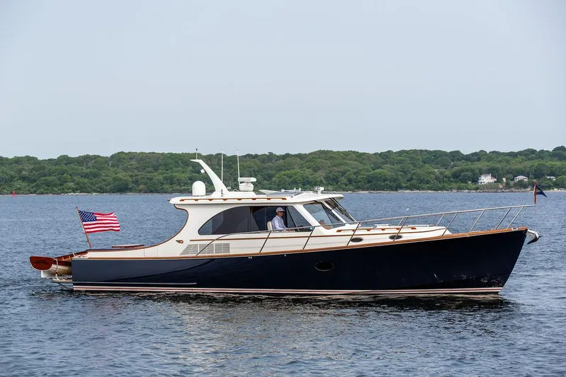 Kite Yacht Photos Pics 2014 Hinckley Talaria 43 yacht cruising on calm waters with American flag.