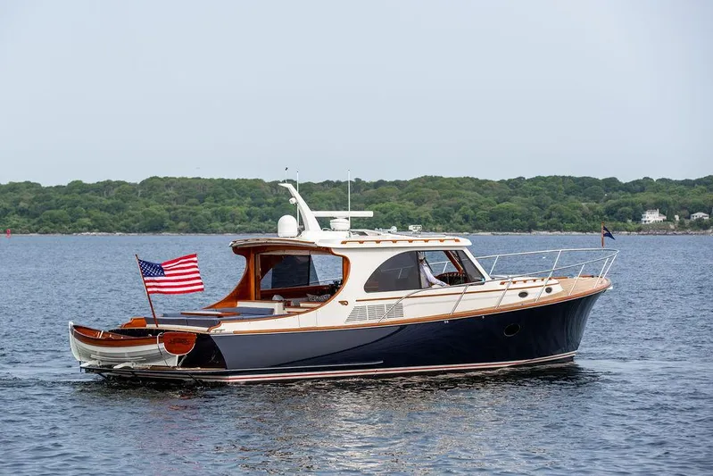Kite Yacht Photos Pics 2014 Hinckley Talaria 43 yacht cruising on calm waters with American flag.