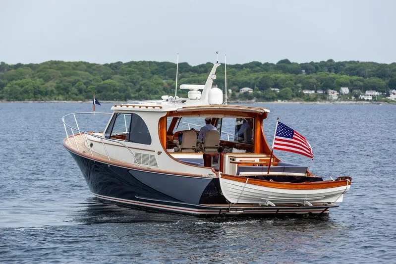 Kite Yacht Photos Pics 2014 Hinckley Talaria 43 yacht cruising on a calm lake with lush green shoreline.