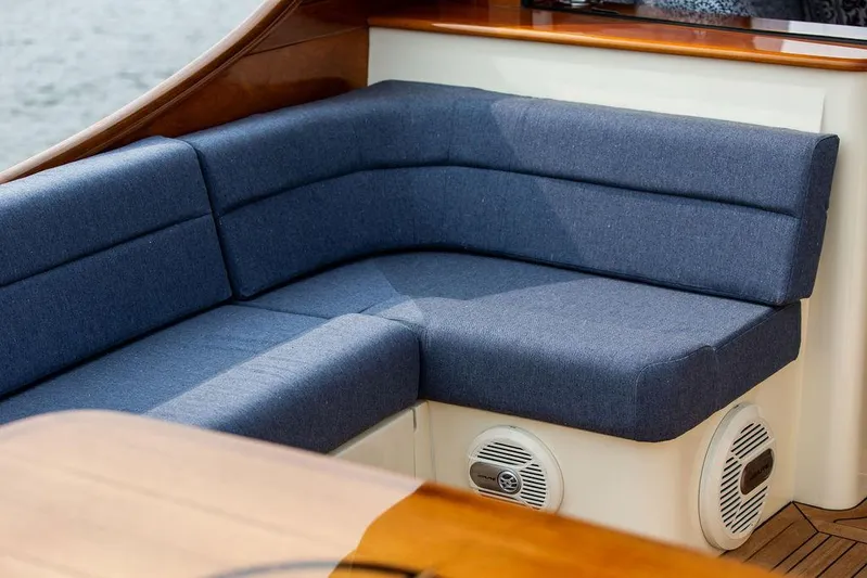 Kite Yacht Photos Pics Hinckley Talaria 43 (2014) yacht interior with blue cushioned seating and wooden accents.