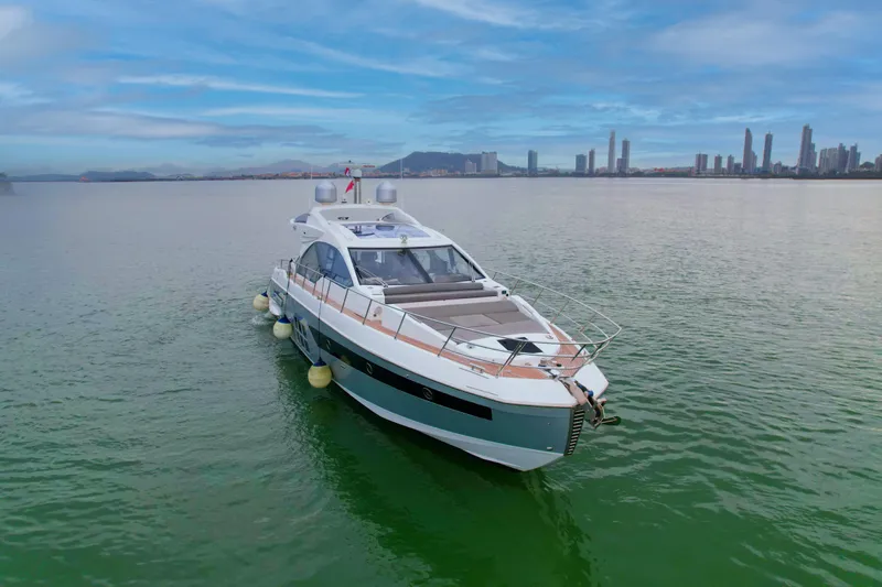  Yacht Photos Pics 2019 Azimut S6 yacht on calm water with city skyline in the background.