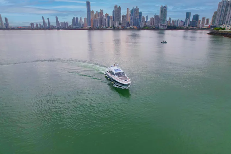  Yacht Photos Pics 2019 Azimut S6 yacht cruising near a city skyline on calm waters.