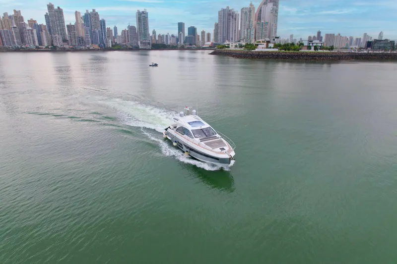  Yacht Photos Pics 2019 Azimut S6 yacht cruising near a city skyline on calm waters.
