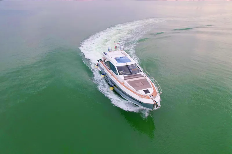  Yacht Photos Pics 2019 Azimut S6 yacht cruising on calm green waters, aerial view.