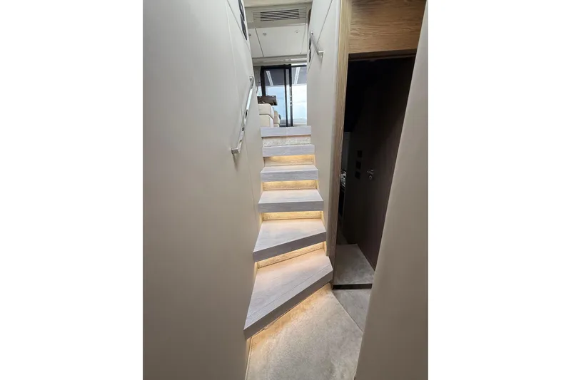  Yacht Photos Pics Staircase with ambient lighting inside a 2019 Azimut S6 yacht, leading to upper deck.
